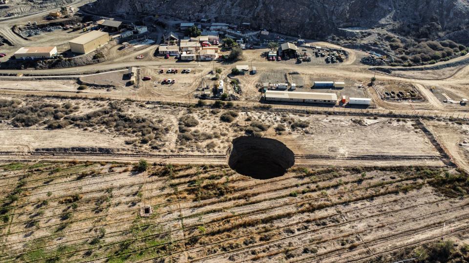 <p>Aerial view taken on August 1, 2022, showing a large sinkhole that appeared over the weekend near the mining town of Tierra Amarilla, Copiapo Province, in the Atacama Desert in Chile. - A 100-metre security perimeter has been erected around the hole which appeared in the Tierra Amarilla municipality near the Alcaparrosa mine operated by Canadian firm Lundin Mining. (Photo by Johan GODOY / AFP) (Photo by JOHAN GODOY/AFP via Getty Images)</p> 