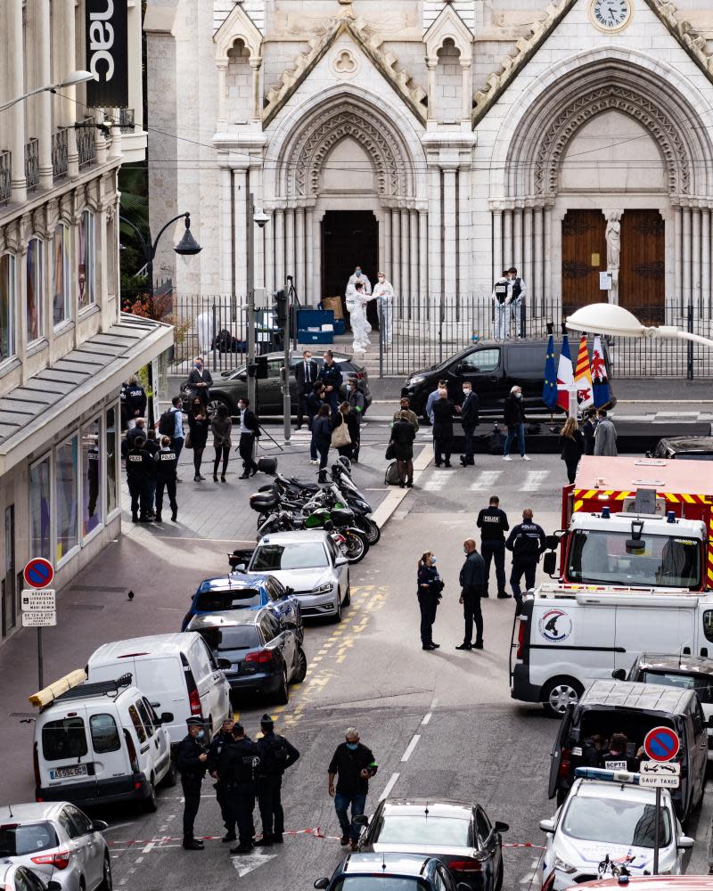 Police stand in front of the church after the attack.