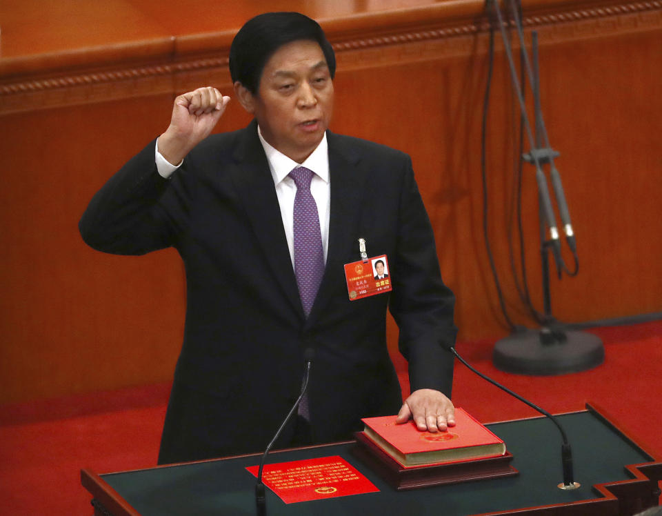 FILE - In this March 17, 2018, file photo, Li Zhanshu, then newly-elected chairman of China's National People's Congress (NPC), takes the oath of office during a plenary session of the NPC in Beijing. Chinese President Xi Jinping is sending the top political ally to attend celebrations of the 70th anniversary of North Korea's founding this weekend, the ruling Communist Party announced Tuesday, Sept. 4, 2018. Analysts said a decision by Xi not to travel to Pyongyang would indicate that Beijing expected further actions from North Korean leader Kim Jong Un, including real signs of progress toward denuclearization. (AP Photo/Mark Schiefelbein, File)
