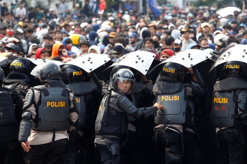 Riot police officers are seen during a protest against the government's labor reforms in "jobs creation" bill in Jakarta