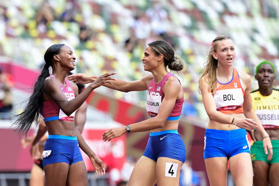 Sydney Mclaughlin reacts after winning the women’s 400m hurdles final with Dalilah Muhammad as Femke Bol looks on (AFP)