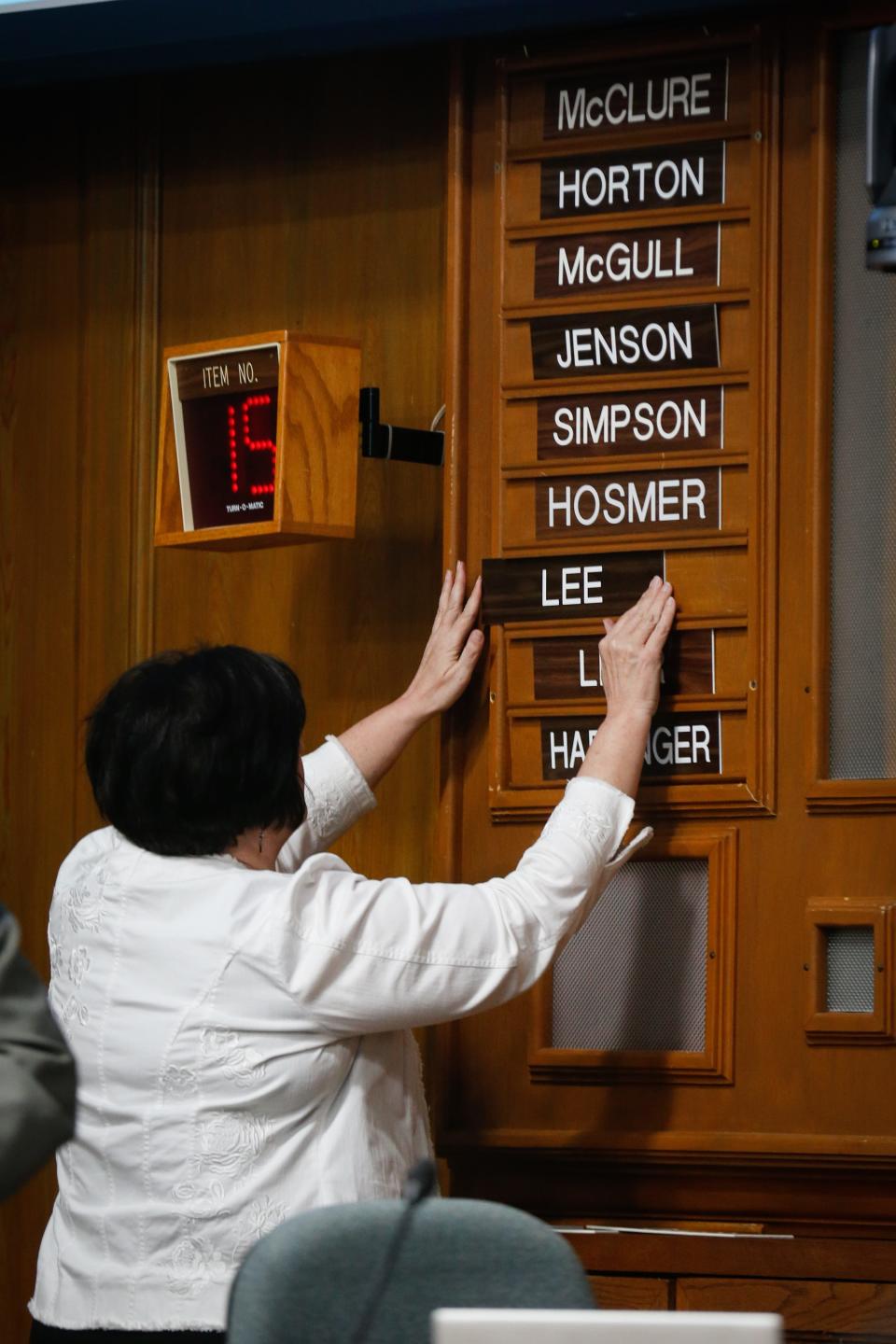 City Council General Seat Councilman Derek Lee's nameplate is added to its spot on the back wall behind the City Council members during the Springfield City Council meeting on Monday, April 17, 2023.