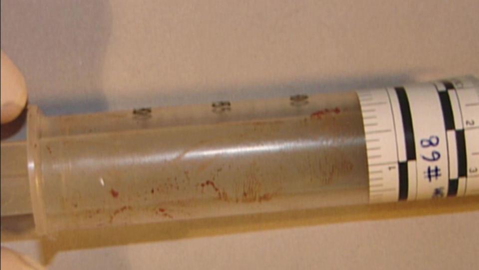 A bloody syringe found in a garbage can in the Dorotik's bathroom. / Credit: San Diego County Sheriff's Department