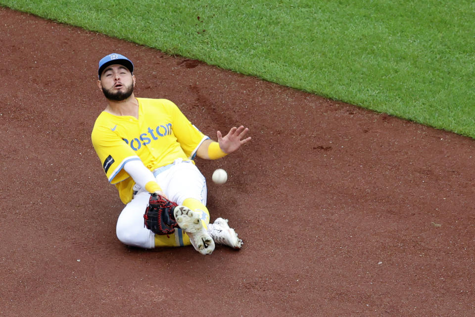 Boston Red Sox left fielder Wilyer Abreu slides to contain the ball on a single by Baltimore Orioles' Adam Frazier during the fifth inning of a baseball game at Fenway Park, Sunday, Sept. 10, 2023, in Boston. Frazier was thrown out at second trying to stretch a single into a double. (AP Photo/Mary Schwalm)