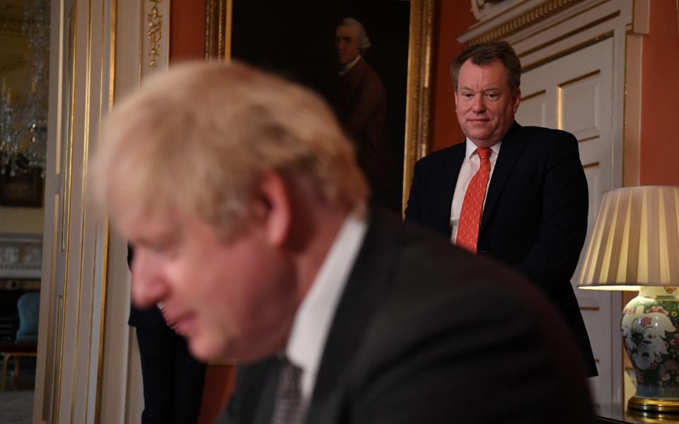 David Frost looks on as Boris Johnson signs the Brexit trade deal - Reuters