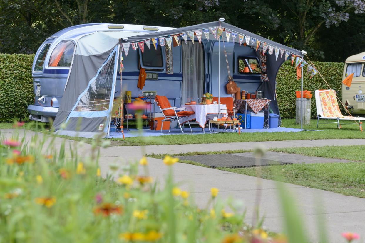 Classic caravans camping in a park in vintage style. The car and caravan are on display during the 2017 Classic Days at Schloss Dyk in Juchen, Germany.