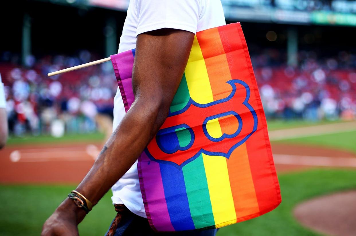 <span class="caption">While professional sports franchises have become more socially conscious, LGBTQ fans and players aren't exactly embraced with open arms.</span> <span class="attribution"><a class="link " href="https://www.gettyimages.com/detail/news-photo/fans-celebrate-pride-night-before-a-game-between-the-boston-news-photo/694315198?adppopup=true" rel="nofollow noopener" target="_blank" data-ylk="slk:Adam Glanzman/Getty Images;elm:context_link;itc:0;sec:content-canvas">Adam Glanzman/Getty Images</a></span>