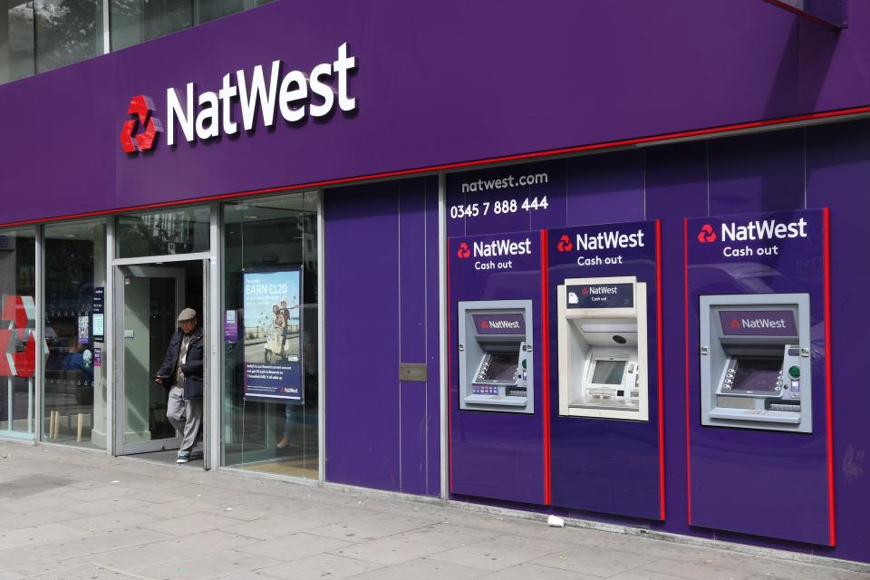 London: Person exits NatWest bank branch in London. National Westminster Bank, known as NatWest is a large British bank with 1,400 branches.