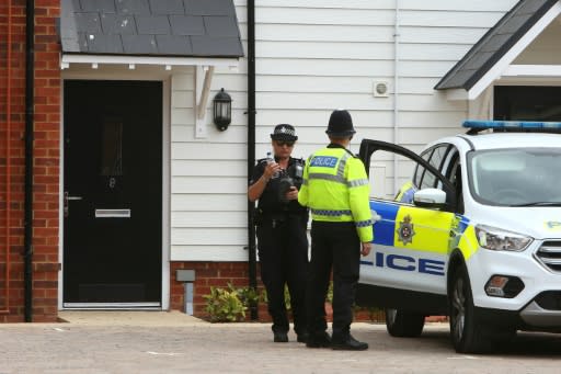 A police officer stands guard outside Charlie Rowley's house in Amesbury, southern England, on July 4, 2018 after a Novichok poisoning days earlier