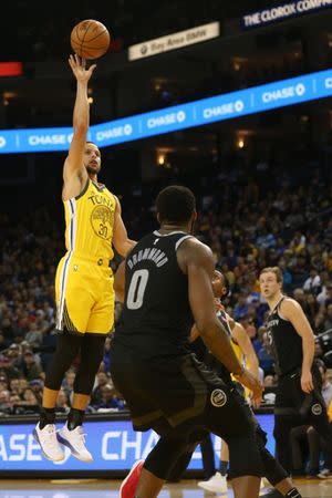 Mar 24, 2019; Oakland, CA, USA; Golden State Warriors guard Stephen Curry (30) makes a shot over Detroit Pistons center Andre Drummond (0) in the fourth quarter at Oracle Arena. Mandatory Credit: Cary Edmondson-USA TODAY Sports