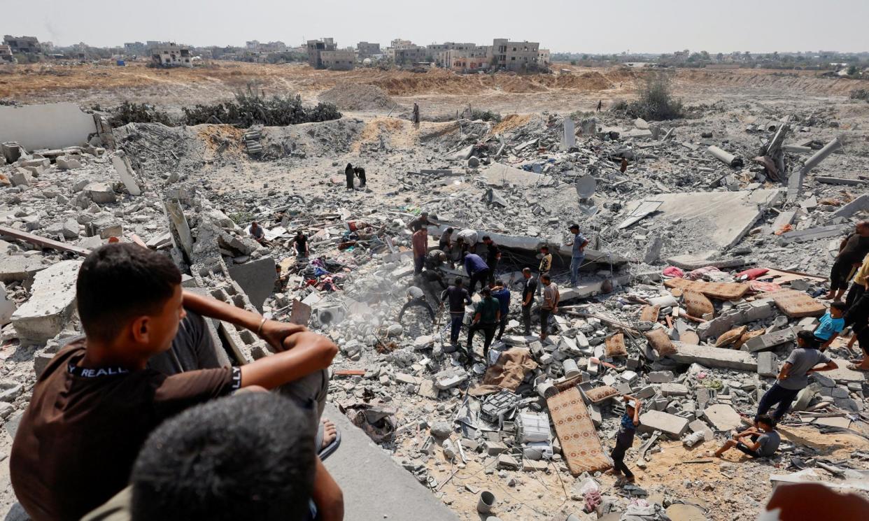 <span>Palestinians inspect the site of an Israeli strike in Khan Younis in Gaza.</span><span>Photograph: Mohammed Salem/Reuters</span>