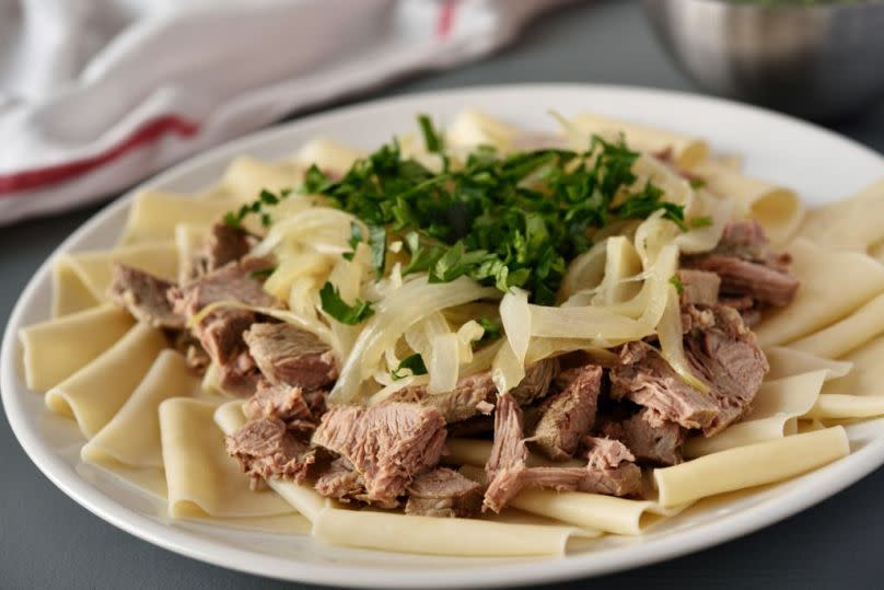 Beshbarmak translates to "five fingers" in Kazakh because nomads traditionally eat this dish with their hands