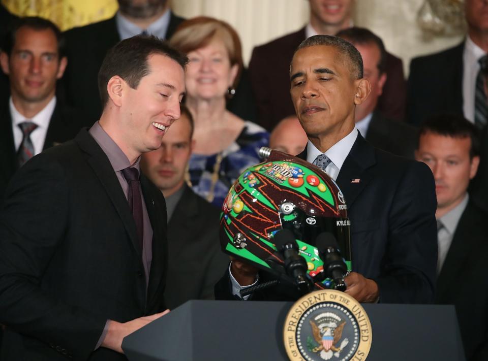 Kyle Busch presents President Barack Obama with a helmet (Getty). 