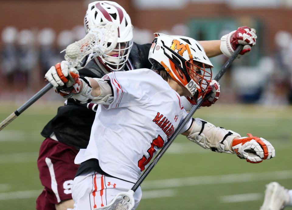From left, Asher Krohn (23) tries to stop Mamaroneck's Rhett Chambers (5) from turning the corner during the Section 1 Class A championship game at Lakeland High School in Shrub Oak May 27, 2022. Scarsdale won the game 12-7.