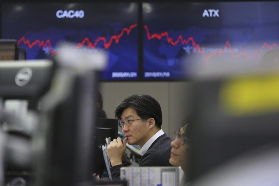 A currency trader watches monitors at the foreign exchange dealing room of the KEB Hana Bank headquarters in Seoul, South Korea, Wednesday, Jan. 22, 2020. Shares advanced in early Asian trading after a slide in U.S. stocks Tuesday as a virus outbreak in China rattled global markets. (AP Photo/Ahn Young-joon)