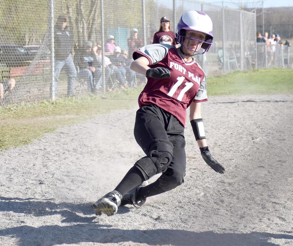 Fort Plain's Marissa Wilder starts her slide and scores the junior varsity Hilltoppers' first run against Sandy Creek Saturday at the New York State Softball Hall of Fame Tournament at the Mudville complex in Herkimer.