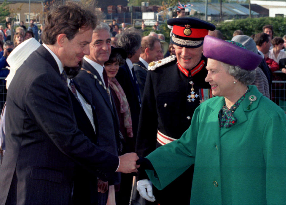 Queen Elizabeth IaI smiles as she is introduced to  Labour party leader Tony Blair during a visit to the Thorn Lighting factory in Spennymoor, County Durham, October 13. The Queen and Prince- Phillip were on a one day visit to the north east were she officially opened a new development for the Korean company Samsung