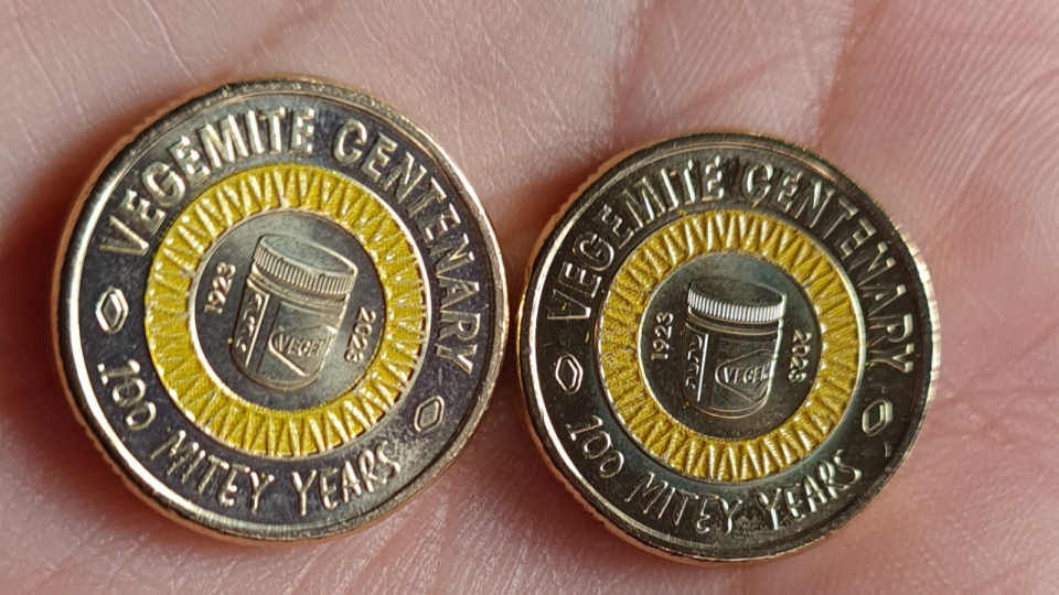 An image of a person holding the Vegemite $2 coins.