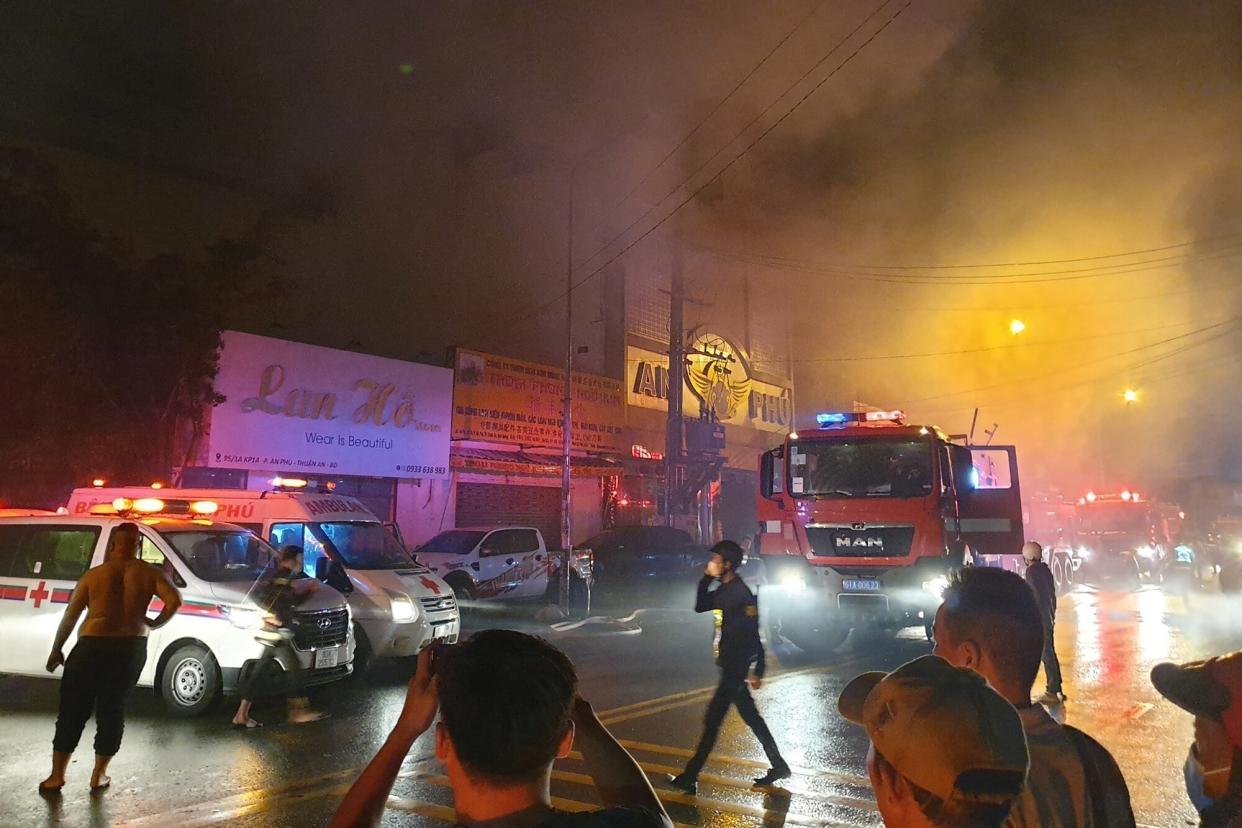 This picture taken on September 6, 2022 and released on September 7 by the Vietnam News Agency shows firefighters at the scene of a deadly fire that engulfed a karaoke bar in Binh Duong province, north of Ho Chi Minh City. - A fire tore through a karaoke bar in Vietnam killing at least 23 people, a local official said September 7.