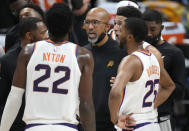 Phoenix Suns head coach Monty Williams, center, confers with players during a timeout late in the second half of Game 4 of an NBA second-round playoff series against the Denver Nuggets, Sunday, June 13, 2021, in Denver. Phoenix won 125-118 to sweep the series. (AP Photo/David Zalubowski)