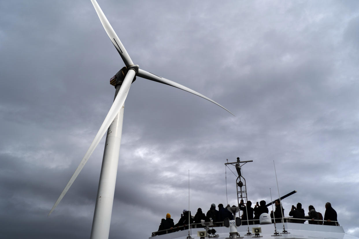 Guests tour one of the turbines of America's first offshore wind farm, owned by the Danish company, Orsted, off the coast of Block Island, R.I., as part of a wind power conference, Oct. 17, 2022. (David Goldman/AP)