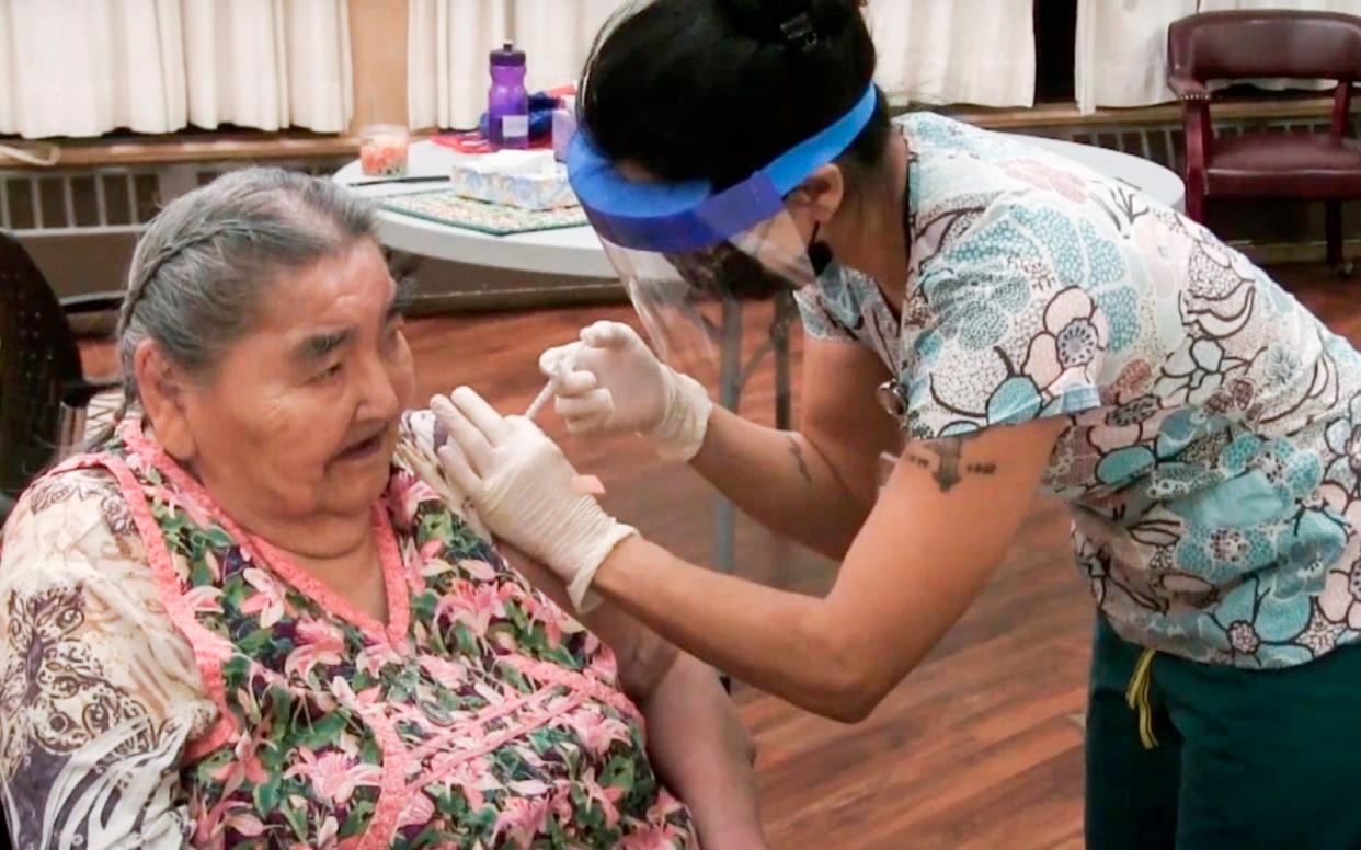 Community health worker Nicole Gregory, gives a Covid-19 vaccine to Virginia Johnston at the Yukon-Koyukuk Elder Assisted Living Facility in Galena, Alaska - Paul Apfelbeck