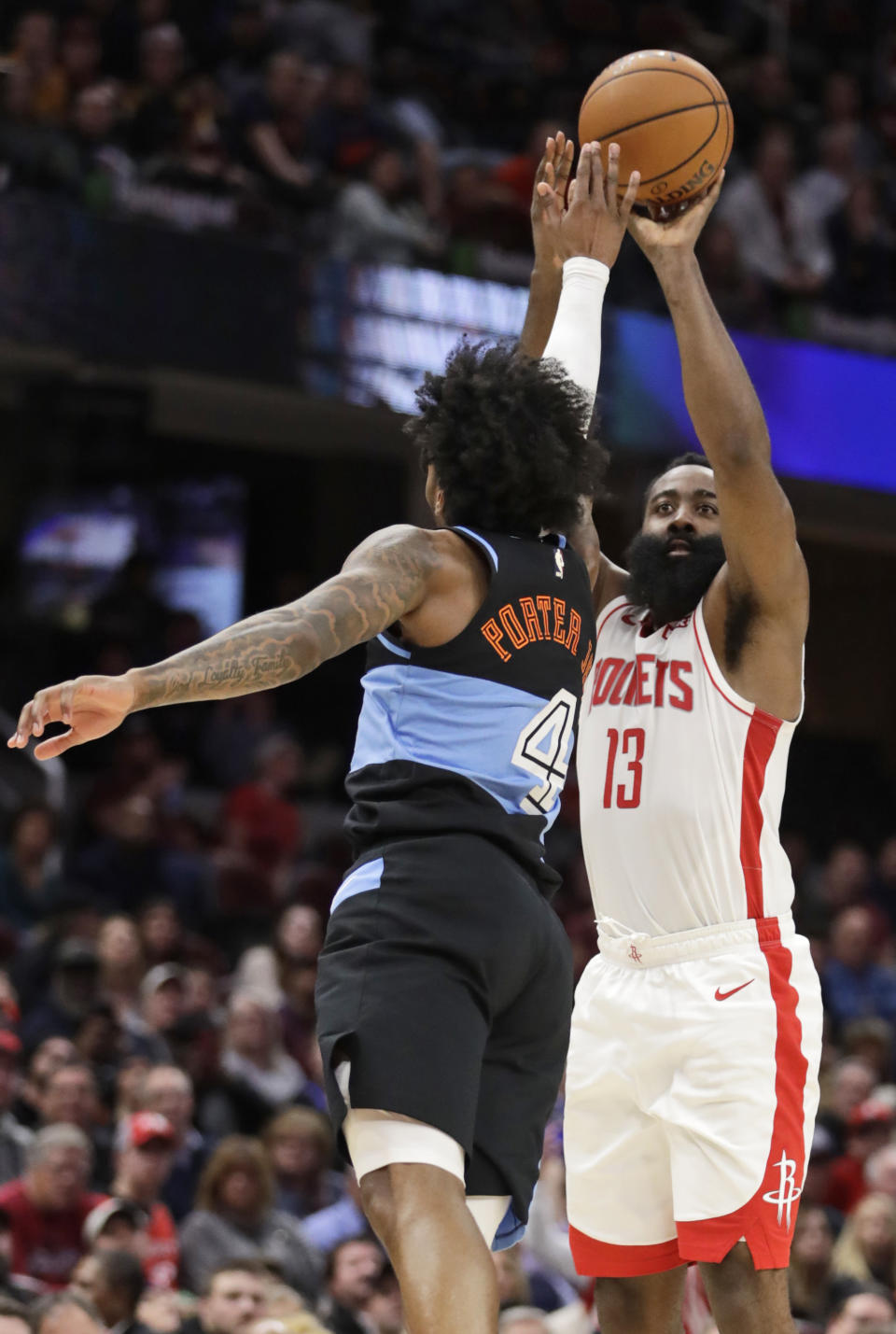 Houston Rockets' James Harden (13) shoots over Cleveland Cavaliers' Kevin Porter Jr. (4) in the second half of an NBA basketball game, Wednesday, Dec. 11, 2019, in Cleveland. Houston won 116-110. (AP Photo/Tony Dejak)