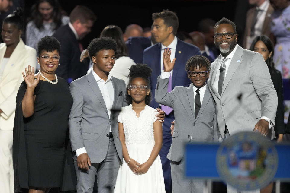 Chicago Mayor Brandon Johnson, right, stands with his family from left, wife Stacie, son Owen, daughter Braedyn, and son Ethan, after becoming the city's 57th mayor Monday, May 15, 2023, in Chicago. (AP Photo/Charles Rex Arbogast)