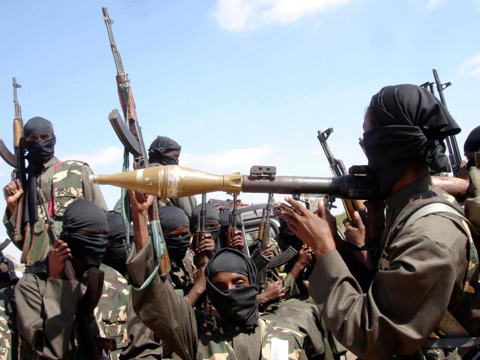 Al-Shabaab militants bearing rifles and a rocket launcher (Reuters)