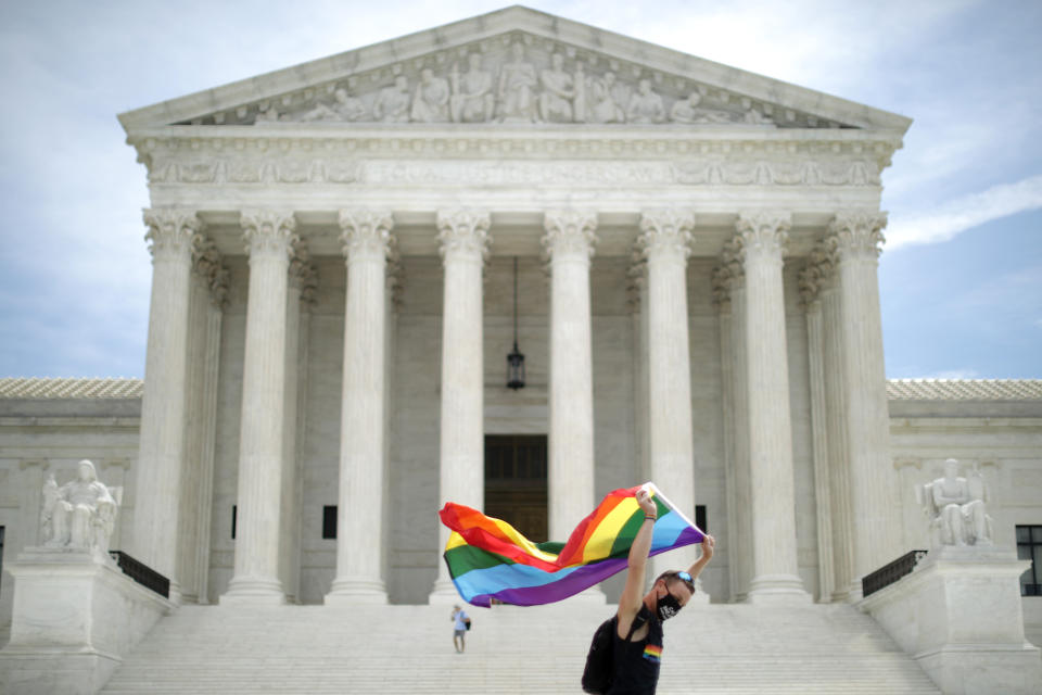 Joseph Fons, holding a Pride Flag, walks back and forth in front of the U.S. Supreme Court building after the court ruled that LGBTQ people can not be disciplined or fired based on their sexual orientation. (Photo: Chip Somodevilla via Getty Images)