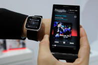 A man displays a Sony SmartWatch during a presentation at the Mobile World Congress on February 28, 2012 in Barcelona. AFP PHOTO/LLUIS GENE