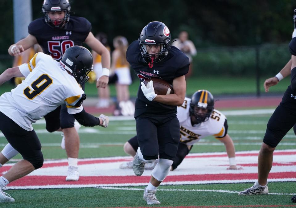 Rye's Archer Fenton (22) breaks a tackle and finds a hole during their 28-2 win over Nanuet in football action at Rye High School on Thursday, September 14, 2023.