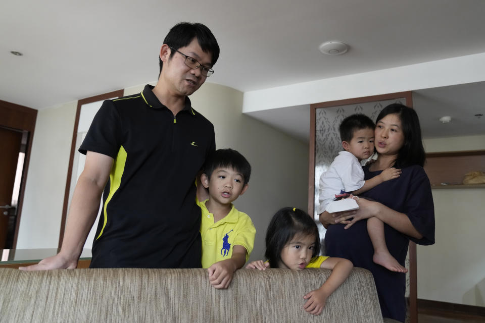 Chinese nationals Li Bin Bin and his wife Nie Yunfeng sing religious songs with their family during a meeting with The Associated Press in Bangkok, Thailand, Tuesday, Sept. 6, 2022. Li and Nie are part of a group belonging to a Chinese church that are seeking refuge in Thailand, saying they face state harassment and possible deportation. (AP Photo/Sakchai Lalit)