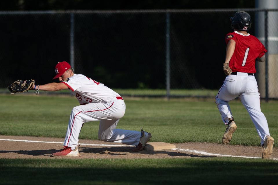 Hudson's Nik Pavia makes the stretch at first base with the throw from the infield before East Side's Noah Pratt crosses the bag.