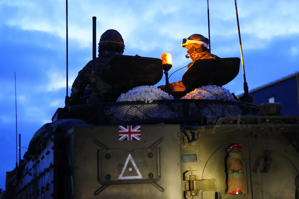 Britain's military officers sit on top of an armoured vehicle at the Tapa Military Camp, in Estonia, Thursday, Jan. 19, 2023. Senior officials from Britain, Poland, the Baltic nations and other European countries met in Estonia on Thursday before the Ramstein gathering. (AP Photo/Pavel Golovkin)