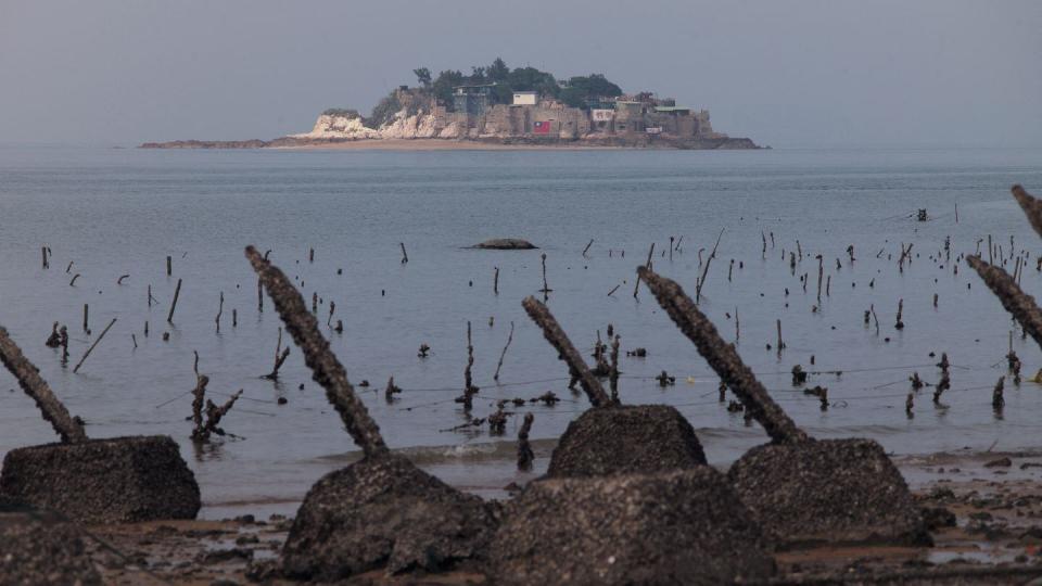 Taiwan's remote Shihyu islet is visible from behind anti-landing spikes on Taiwan's front-line island of Little Kinmen on Dec. 5, 2023. (Sam Yeh/AFP via Getty Images)