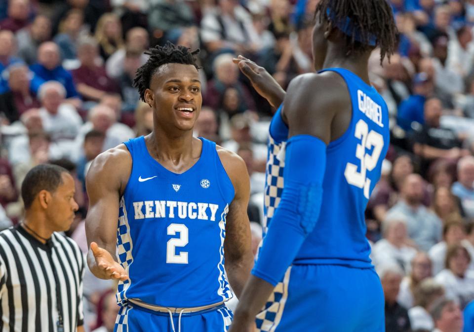 Kentucky forwards Jarred Vanderbilt (2) and forward Wenyen Gabriel (32) shake hands during a game against Texas A&M on Feb. 10, 2018.