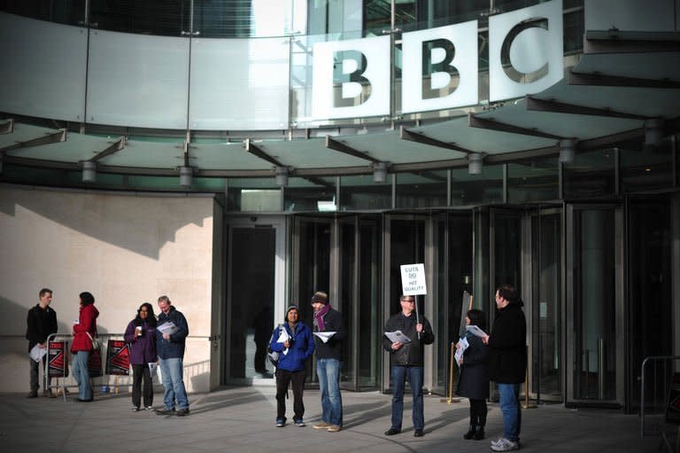 BBC employees hold placards outside Broadcasting House in central London on February 18, 2013. BBC journalists staged a 24-hour strike on Monday in protest at job cuts, preventing the transmission of the flagship Today morning news programme and several other television and radio shows