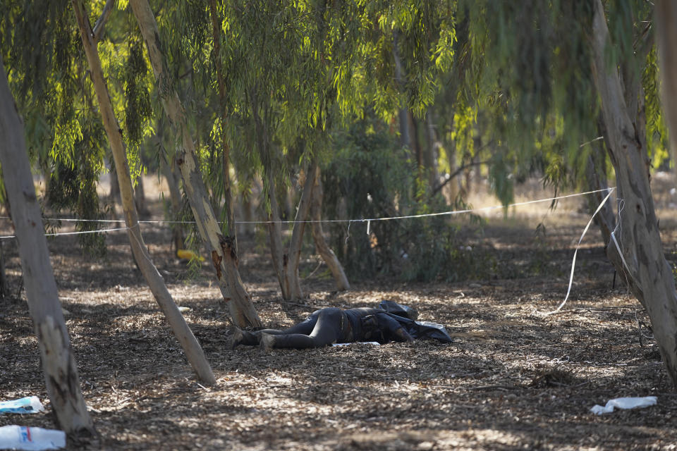 The body of a killed Hamas militant lies on the ground at the site of a music festival, near the border with Gaza Strip in southern Israel, Thursday. Oct. 12, 2023. At least 260 Israeli festivalgoers were killed during the attack last Saturday. (AP Photo/Ohad Zwigenberg)