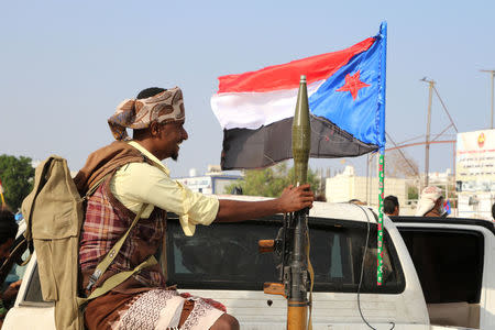 A bodyguard of a southern Yemeni separatist leader holds an RPG launcher as he rides on the back of a pick-up truck at the site of an anti-government protest in Aden, Yemen January 28, 2018. REUTERS/Fawaz Salman