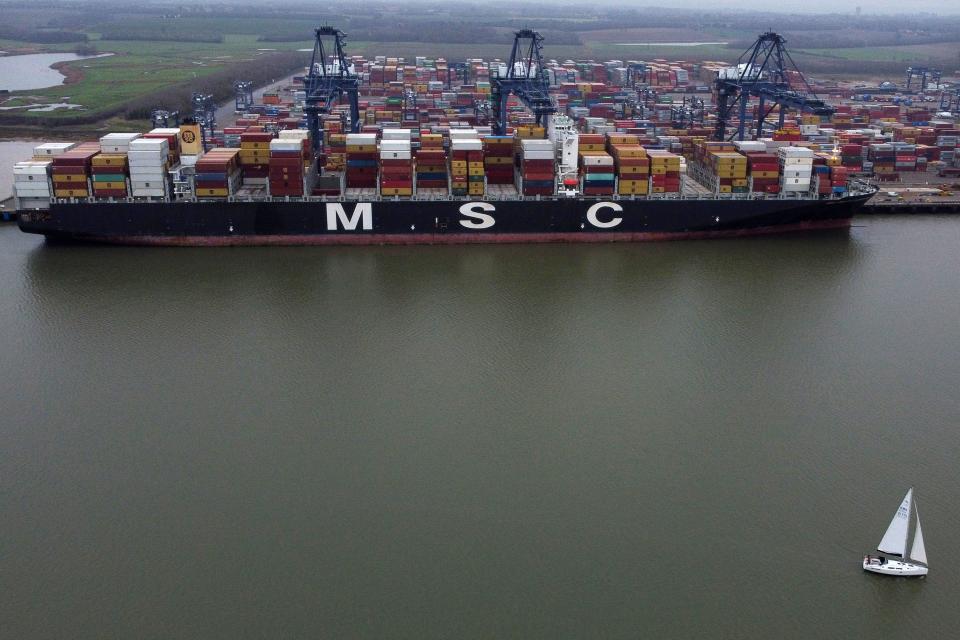 An aerial view shows a sail boat passing Container ship MSC Maria Saveria docked in the port of Felixstowe, east of London on December 12, 2020. - Food shortages, tailbacks and congested ports: as talks with Brussels remain unresolved three weeks before leaving the EU single market, the UK is preparing for a chaotic "no-deal". (Photo by BEN STANSALL / AFP) (Photo by BEN STANSALL/AFP via Getty Images)