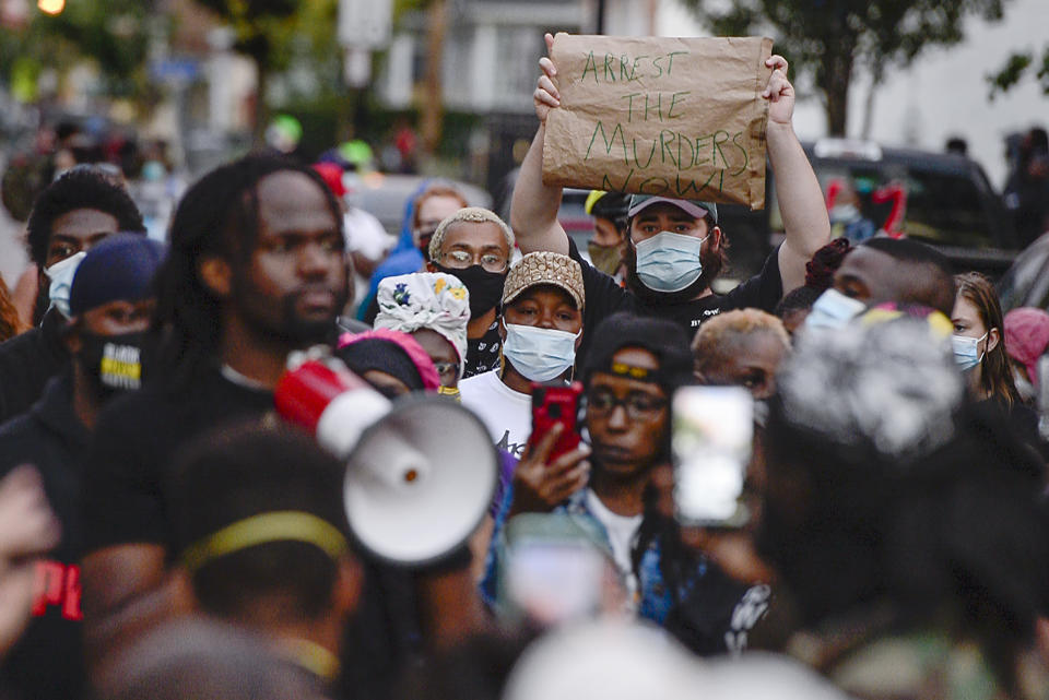 FILE - In this Sept. 2, 2020, file photo, a crowd of protesters gather in Rochester, N.Y., near the site where Daniel Prude was restrained by police officers. In a decision announced Tuesday, Feb. 23, 2021, a grand jury voted not to charge officers shown on body camera video holding Daniel Prude down naked and handcuffed on a city street last winter until he stopped breathing. His brother Joe Prude said Wednesday, Feb. 24 he had viewed police body camera footage showing what happened after officers caught up with Daniel Prude, naked on a frigid March night, as irrefutable proof of a crime. (AP Photo/Adrian Kraus, File)