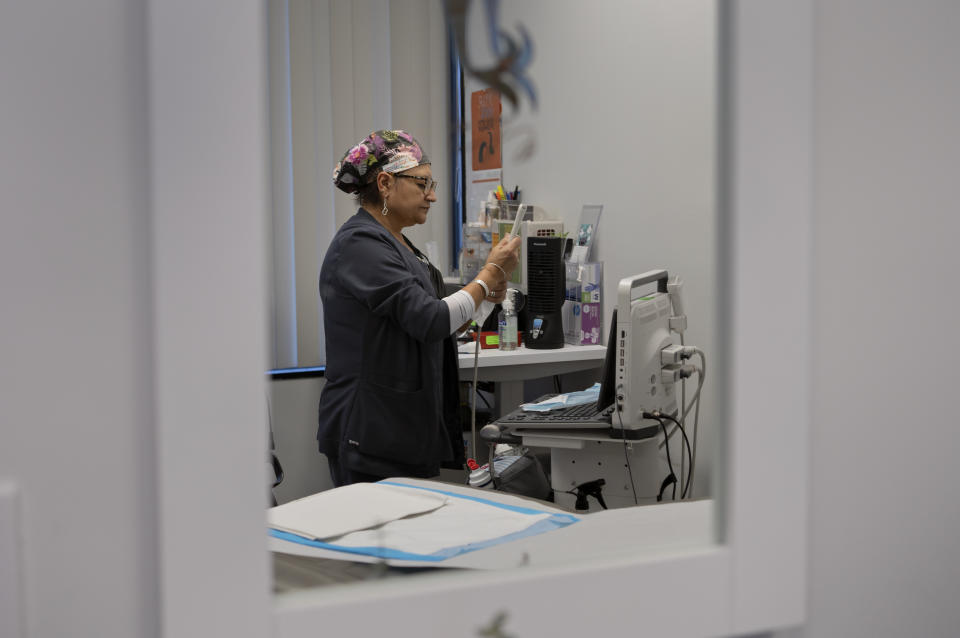 Glenda Lima cleans ultrasound equipment at Houston Women's Reproductive Services in Texas. (Danielle Villasana for The Washington Post)