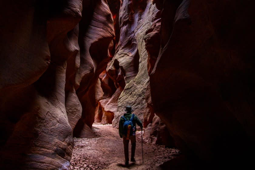 A photo of a lone hiker in Buckskin Gulch near Kanab, Utah.