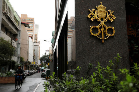 A cyclist passes the Vatican's Nunciature, or embassy, in Taipei, Taiwan March 8, 2018. REUTERS/Tyrone Siu