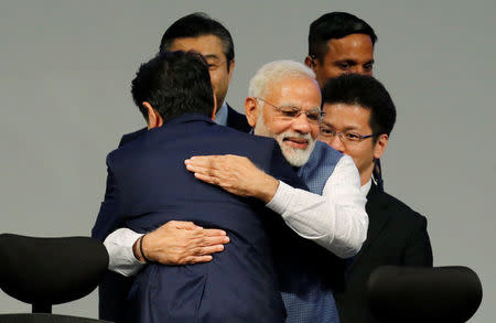 India's Prime Minister Narendra Modi (R) hugs his Japanese counterpart Shinzo Abe during the India-Japan Annual Summit, in Gandhinagar, India, September 14, 2017. REUTERS/Amit Dave