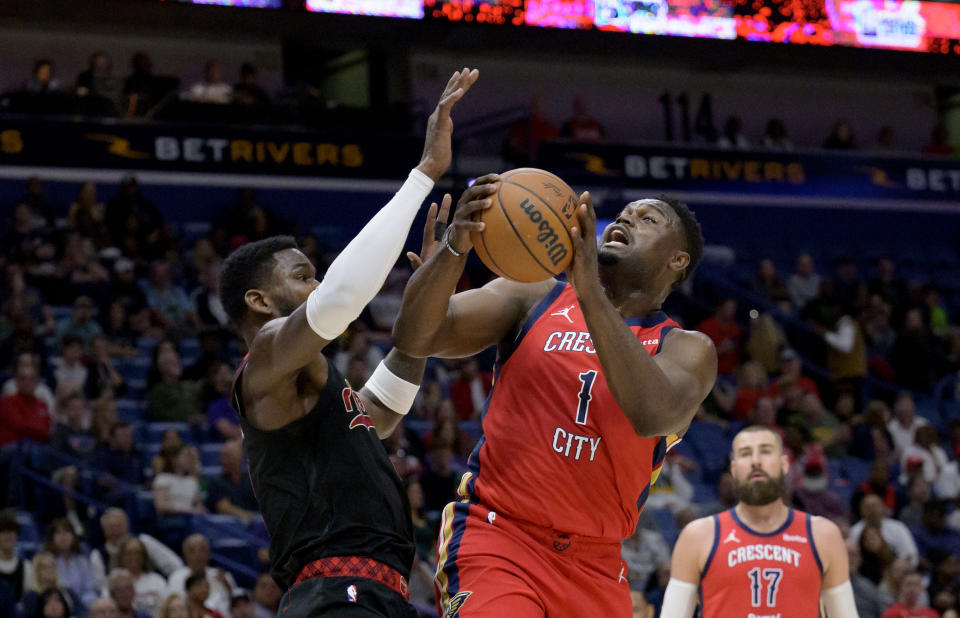 New Orleans Pelicans forward Zion Williamson (1) shoots against Portland Trail Blazers center Deandre Ayton (2) during the first half of an NBA basketball game in New Orleans, Saturday, March 16, 2024. (AP Photo/Matthew Hinton)