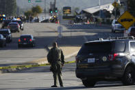 A deputy stands near a scene where an SUV struck Los Angeles County sheriff's recruits in Whittier, Calif., Wednesday, Nov. 16, 2022. The vehicle struck several Los Angeles County sheriff's recruits on a training run around dawn Wednesday, some were critically injured, authorities said. (AP Photo/Jae C. Hong)