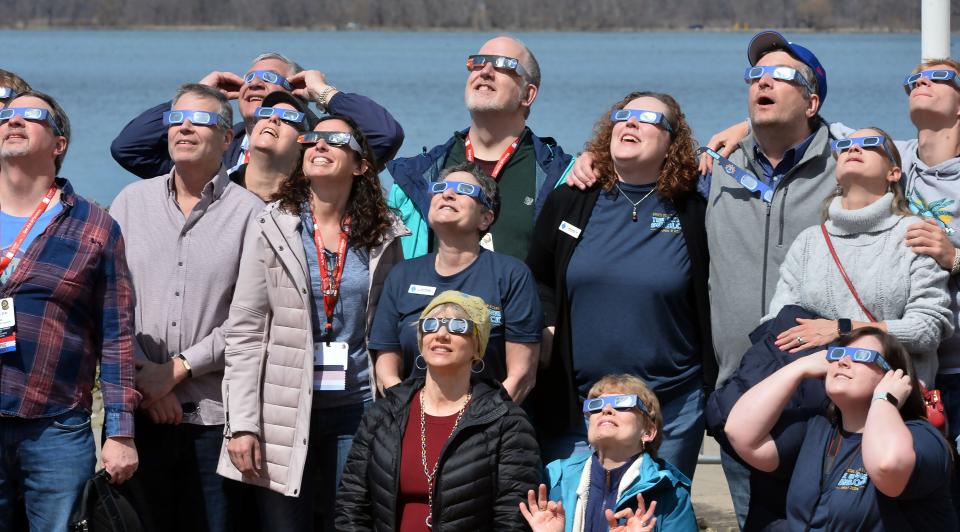 Crowds watch the total solar eclipse from the north patio of the Bayfront Convention Center in Erie on Monday.