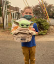 Five-year-old Carver holds up a Baby Yoda toy on Saturday, Sept. 12, 2020 in Scappoose, Oregon. Carver donated the toy to Oregon firefighters, who have been having fun posing the tiny green Force user on the fire lines since. Beleaguered firefighters in the western United States have a new force on their side: Baby Yoda. Carver and his grandmother delivered a toy version of the character from "The Madalorian" series to a donation center for firefighters along with a note that read, “Here is a friend for you in case you get lonely.” Since then, Baby Yoda has been to four wildfires in two states. (Courtesy of Tyler Eubanks)